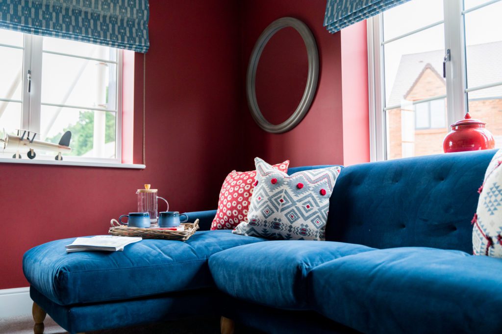 Red lounge at Millers Gate Showhome | Fletchers | Case Study | Reech