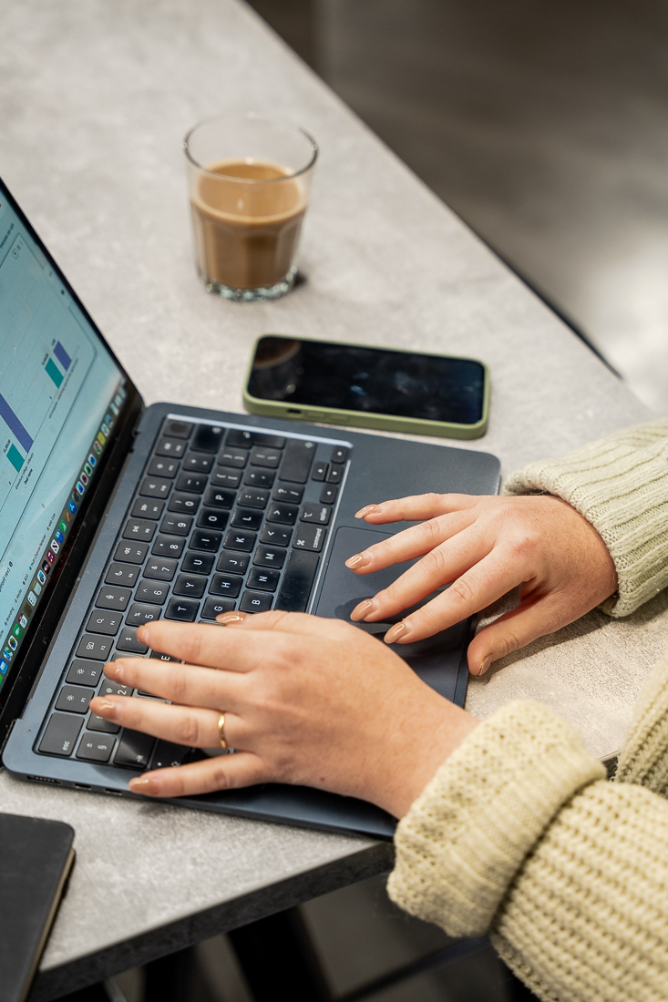 Digital marketer reviewing graphs and charts - Reech Agency