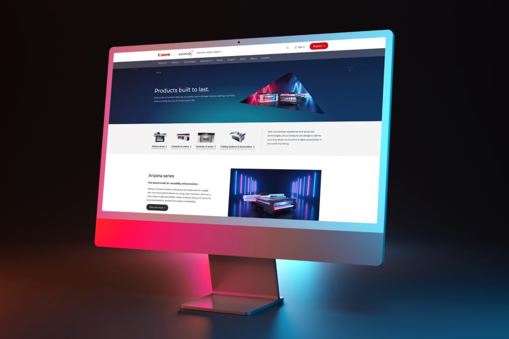 A high-quality custom website design for Canon displayed on a modern desktop monitor with neon backlight