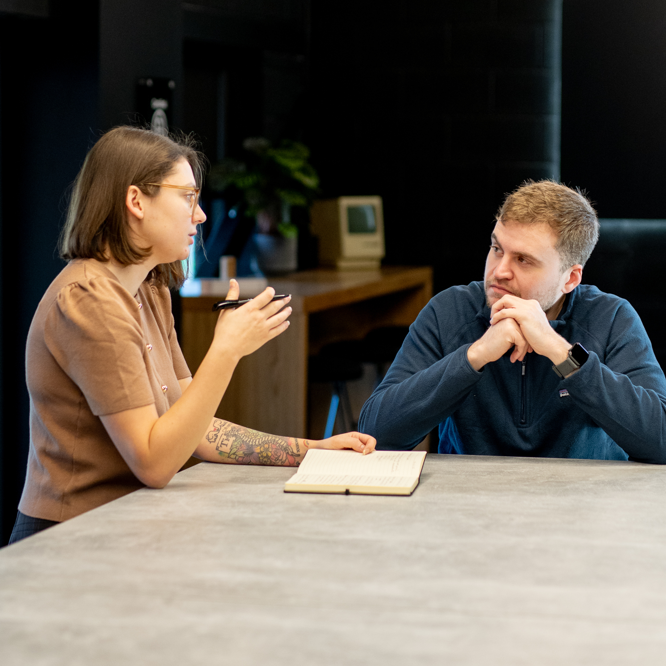 Marketing professionals collaborating and brainstorming digital advertising trends in a meeting area