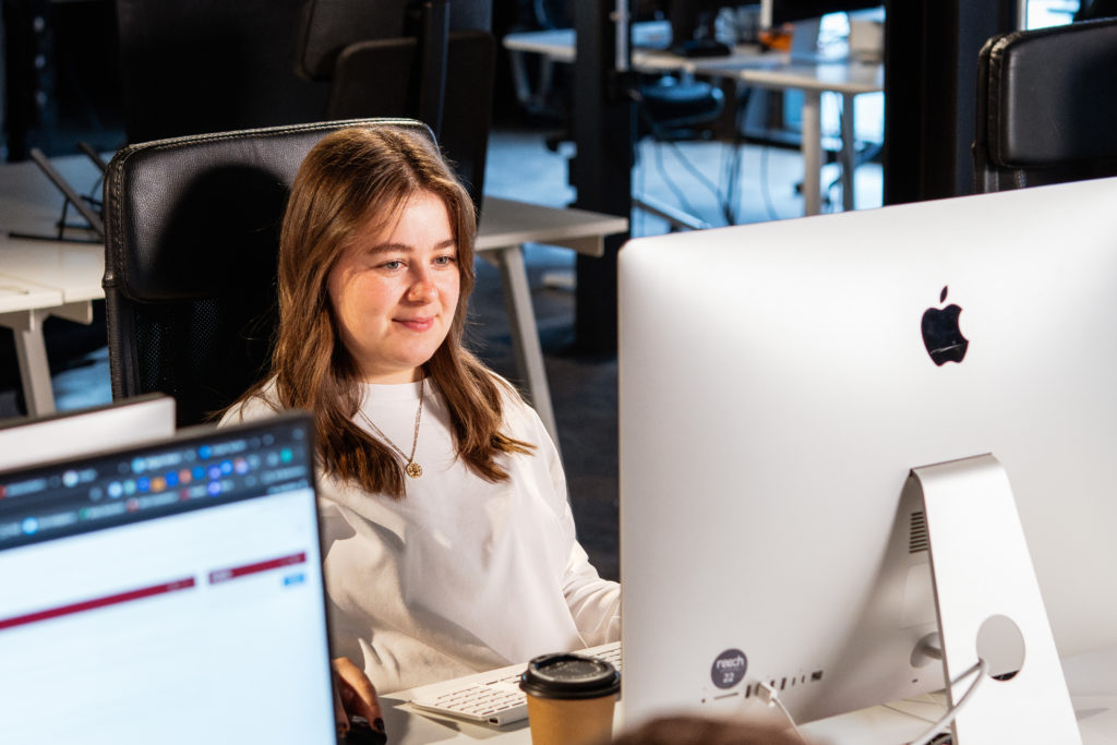 A professional services team member working at an office desk, implementing an SEO strategy to attract high-value clients